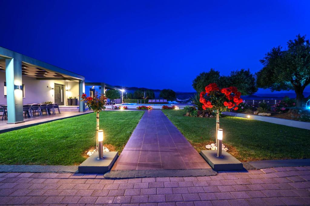 A garden outside Mythic Olive villa - Heated Pool - Amazing view
