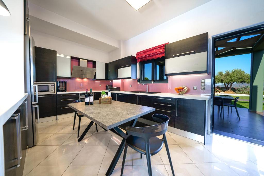 A kitchen or kitchenette at Mythic Olive villa - Heated Pool - Amazing view
