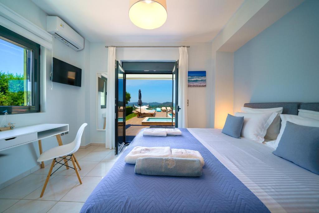 A bed or beds in a room at Mythic Olive villa - Heated Pool - Amazing view