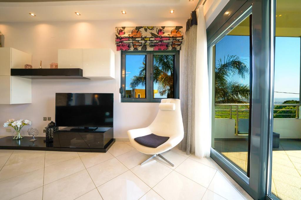 A television and/or entertainment centre at Mythic Olive villa - Heated Pool - Amazing view
