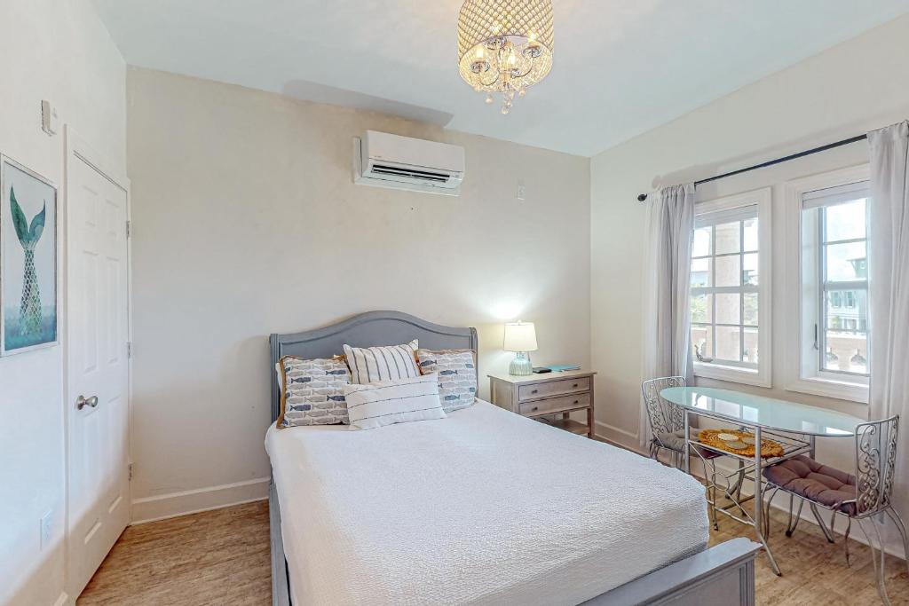 a bedroom with a bed and a desk and a window at Village of South Walton B247 in Inlet Beach