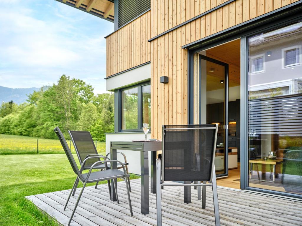 eine Terrasse mit Stühlen und einem Tisch auf einer Terrasse in der Unterkunft PureEscape in Faistenau