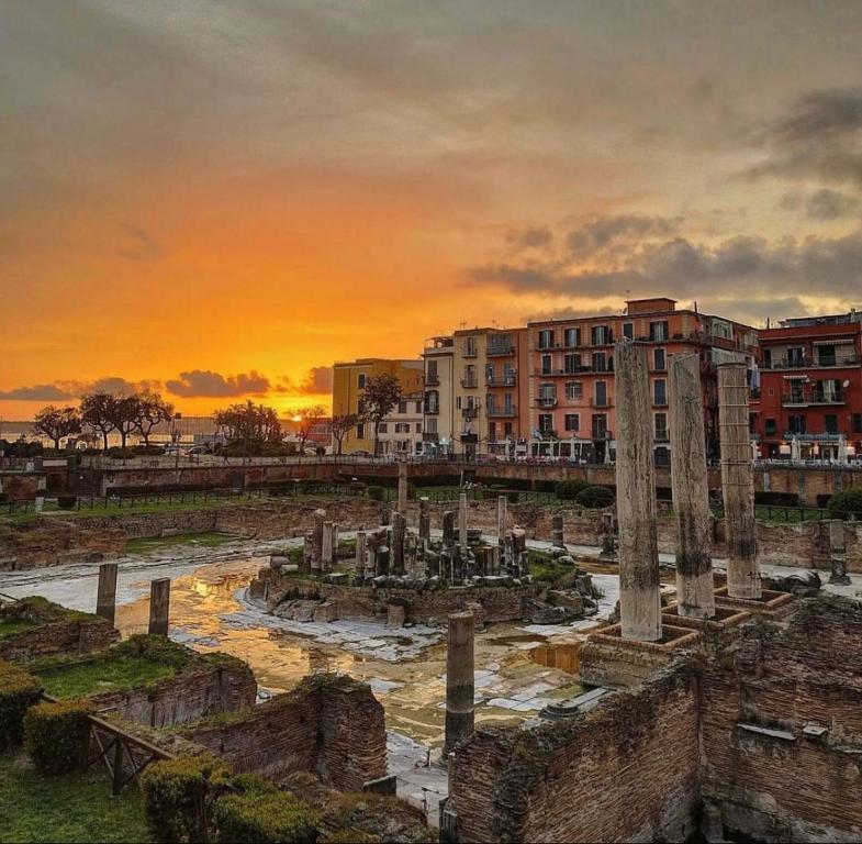 a painting of the ruins of the roman forum at sunset at IL COVO DEL PESCATORE in Pozzuoli