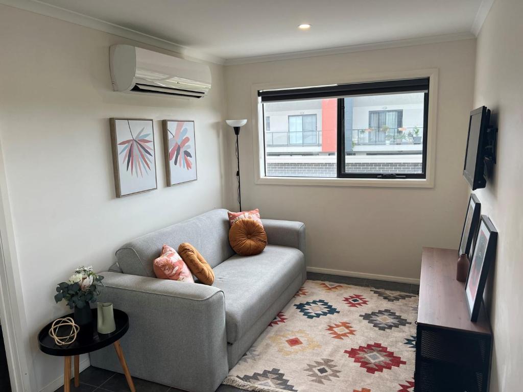 a living room with a couch and a window at Adorable 1 bedroom Unit in Coombs in Weston Creek