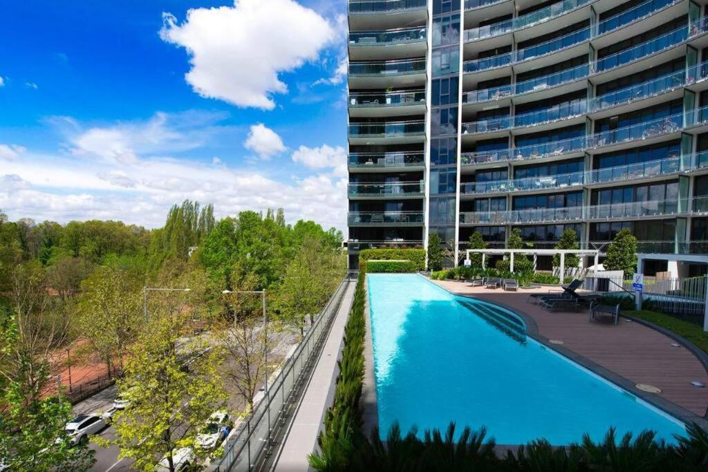 a large apartment building with a large swimming pool at Manhattan - CBD - Canberra in Canberra