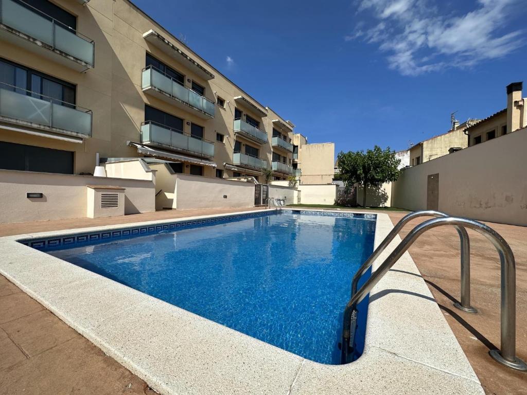 a swimming pool in front of a building at Alba in Sant Feliu de Guíxols