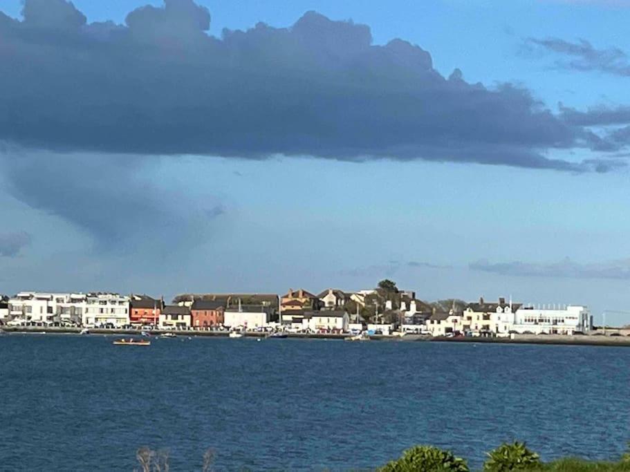 a large body of water with buildings and a city at Seaview Terrace in Skerries