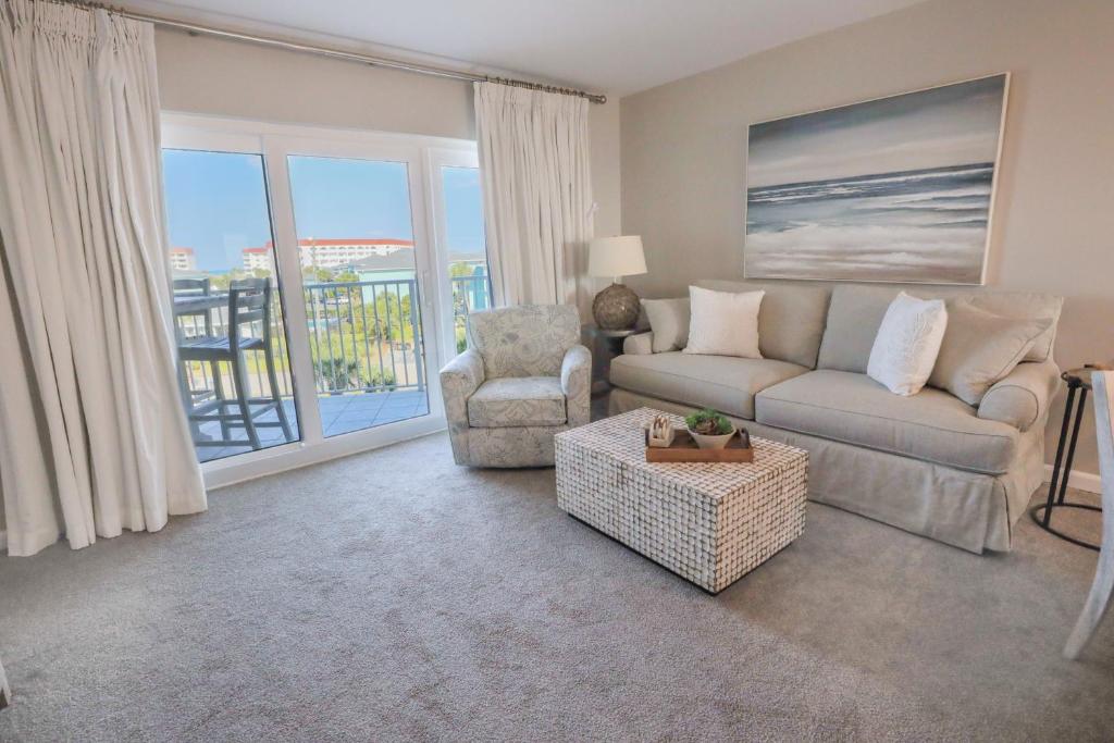 a living room with a couch and a chair at SeaCrest 413 condo in Fort Walton Beach
