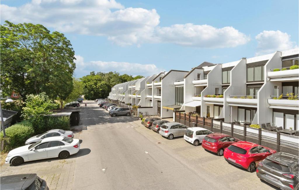 a row of cars parked in a parking lot next to buildings at Stunning Apartment In Helsingr With Wifi in Helsingør