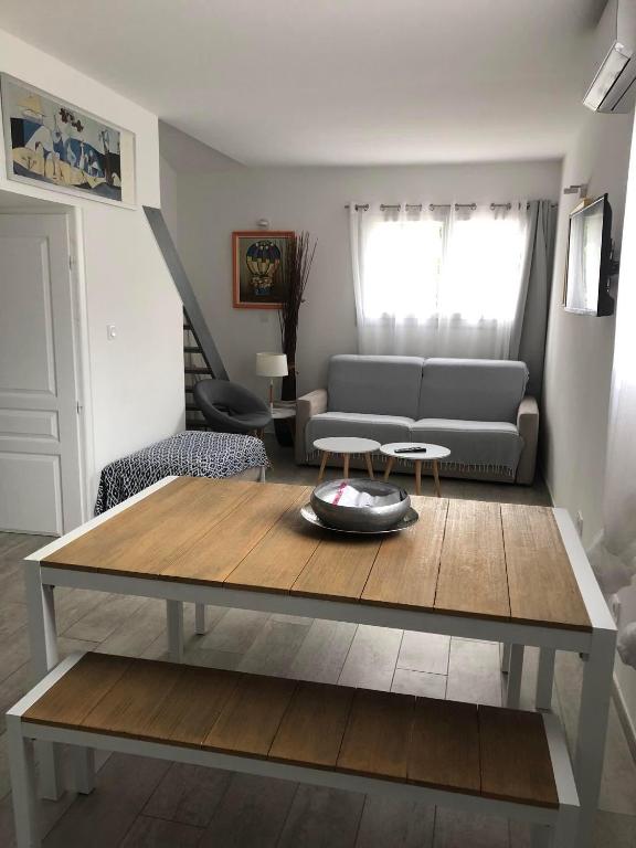 a living room with a couch and a table at Maxima Sunset in Sainte-Maxime