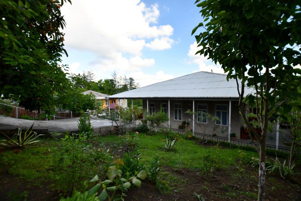 a house with a garden in front of it at Nika house in Tskaltubo