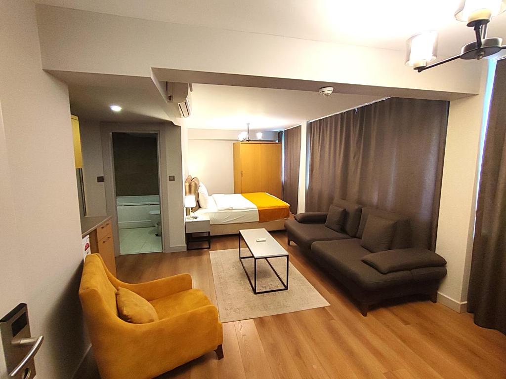 a living room with a couch and a bed at Galata World Hotel in Istanbul