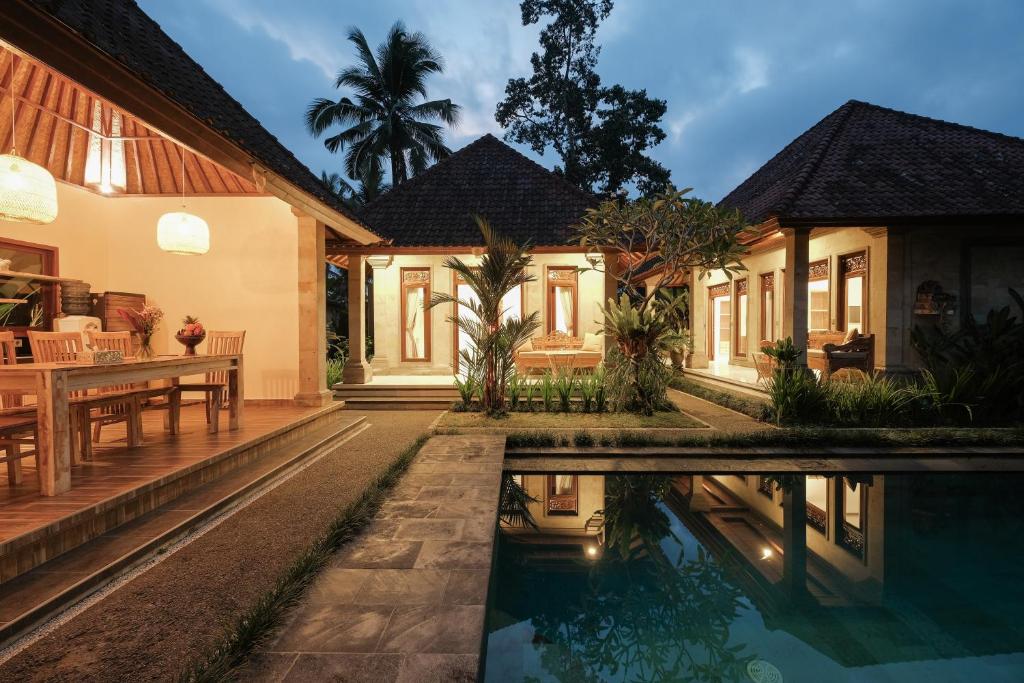 an exterior view of a house with a swimming pool at Pondok Sebali Private Villa in Ubud