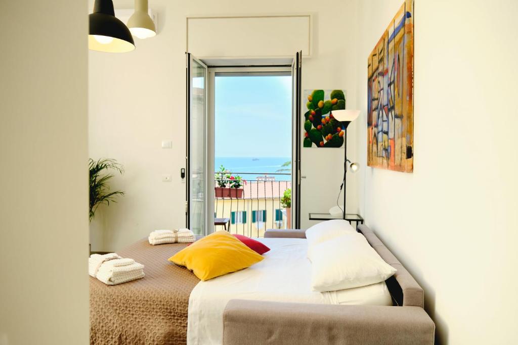 a bedroom with a bed with a view of the ocean at Riflessi DaMare Room & Apartment in Salerno