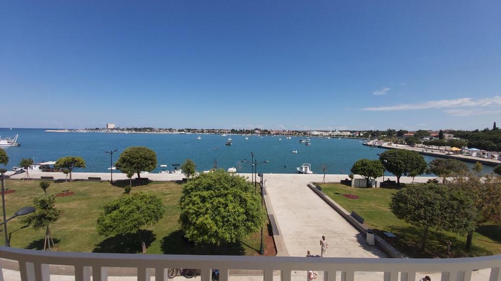 a view of the water from the balcony of a building at Bella Vista Apartments in Umag