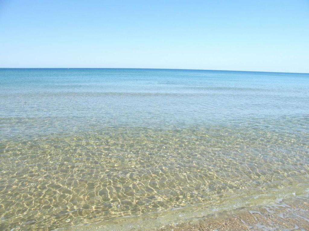 a body of water with rocks in the water at Residence Punta d'Angelo in Scoglitti