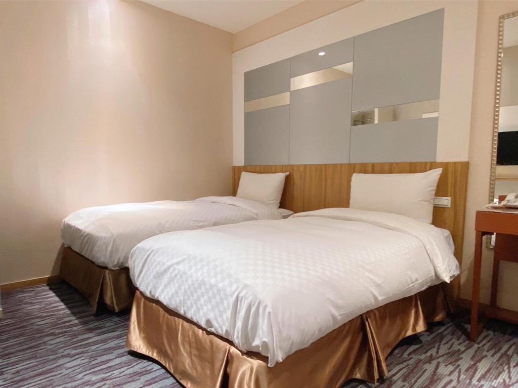 Postel nebo postele na pokoji v ubytování Muzik Hotel - Ximending Xining Branch