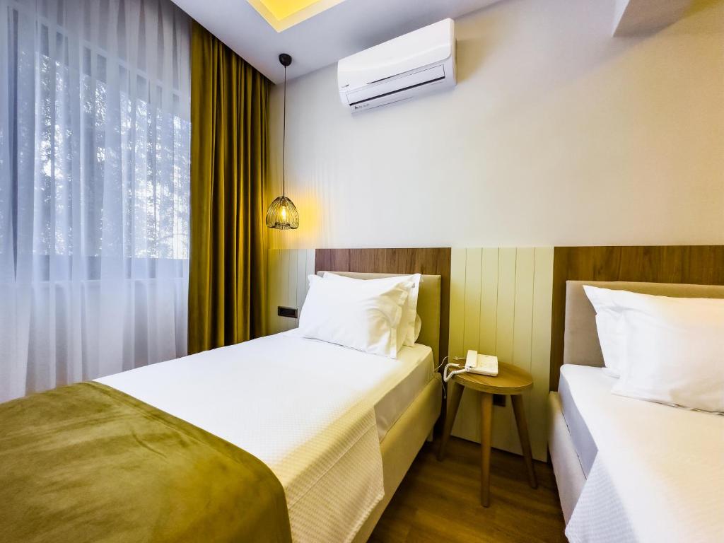 Postel nebo postele na pokoji v ubytování Dedeoğlu Port Hotel