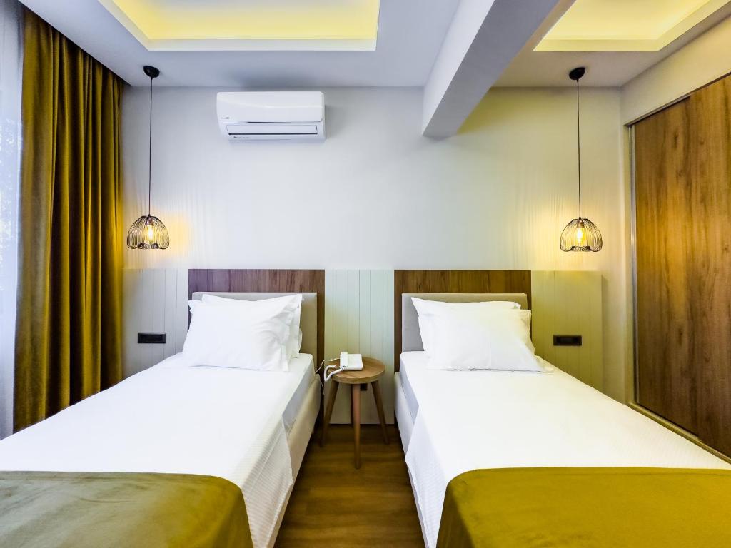 Postel nebo postele na pokoji v ubytování Dedeoğlu Port Hotel
