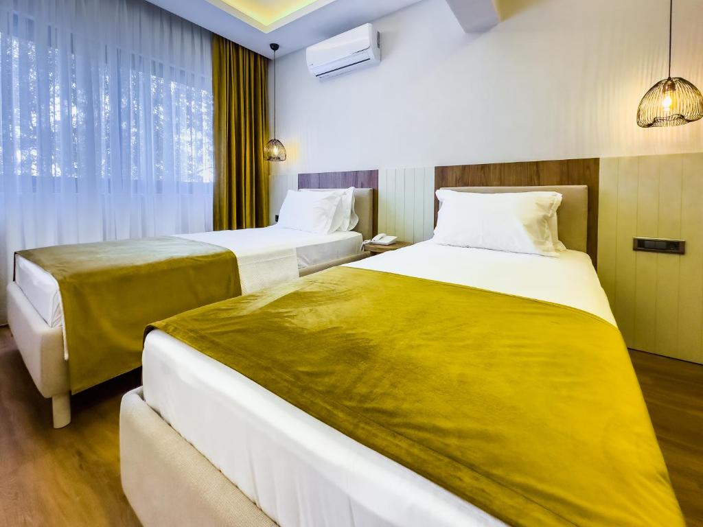Postel nebo postele na pokoji v ubytování Dedeoğlu Port Hotel