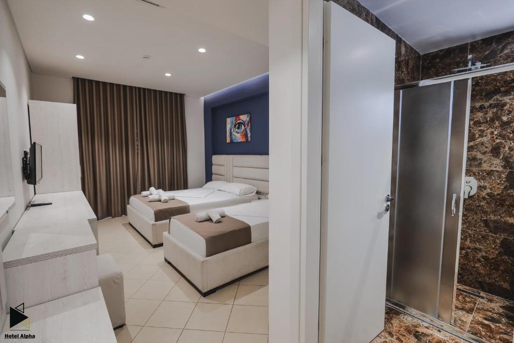 Postel nebo postele na pokoji v ubytování Hotel Alpha