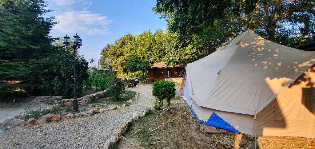 a large tent sitting on the side of a road at Magic Garden Emperor Bell Tent in Vama Veche