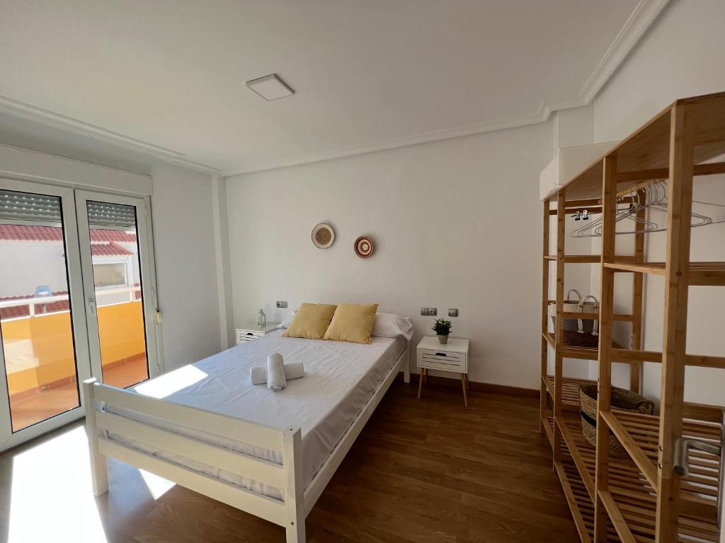 a white bedroom with a bed and a bunk room at La Pita in Almería