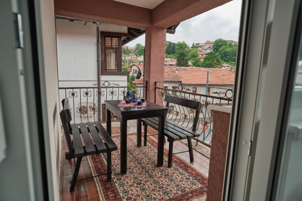 a balcony with a table and two chairs on it at Apartment Bistrik medresa in Sarajevo