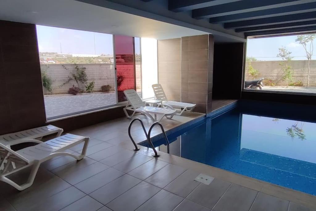 a room with a swimming pool and two chairs at Carsija Life 2 in Avsallar