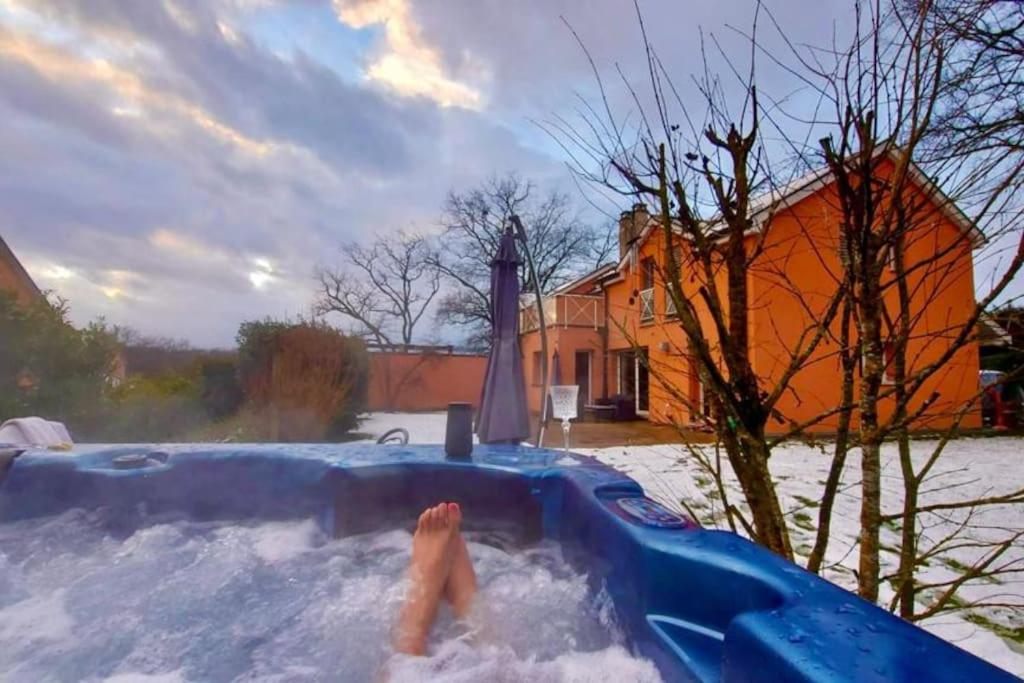 a person in a jacuzzi tub in a yard at Spacious Apartment in luxurious Villa-Geneva in Geneva