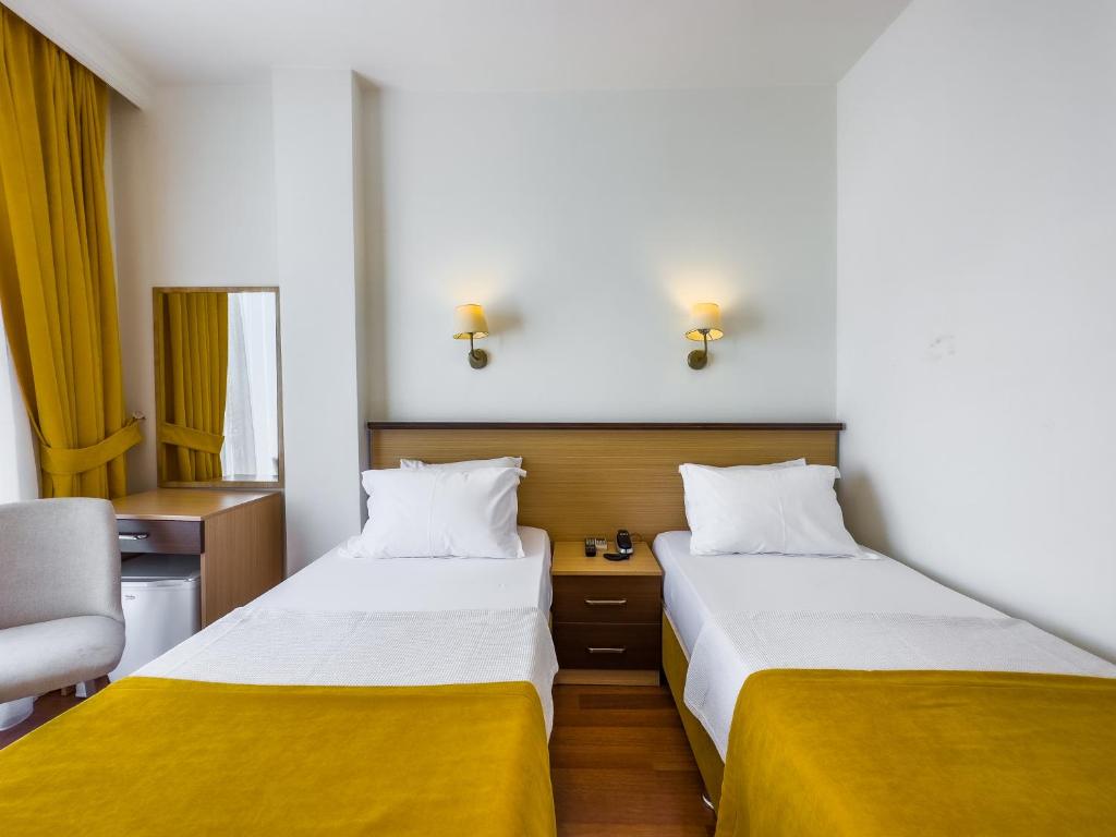 Postel nebo postele na pokoji v ubytování Dedeoğlu Port Hotel
