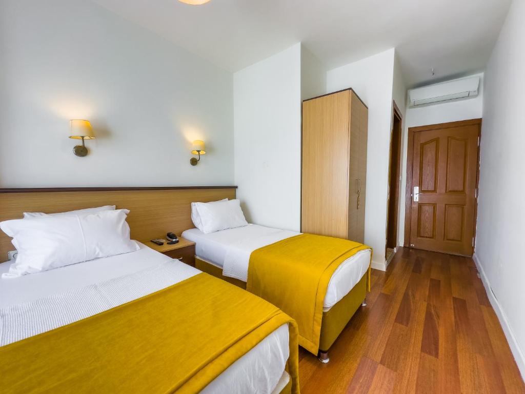 Postel nebo postele na pokoji v ubytování Dedeoğlu Port Hotel