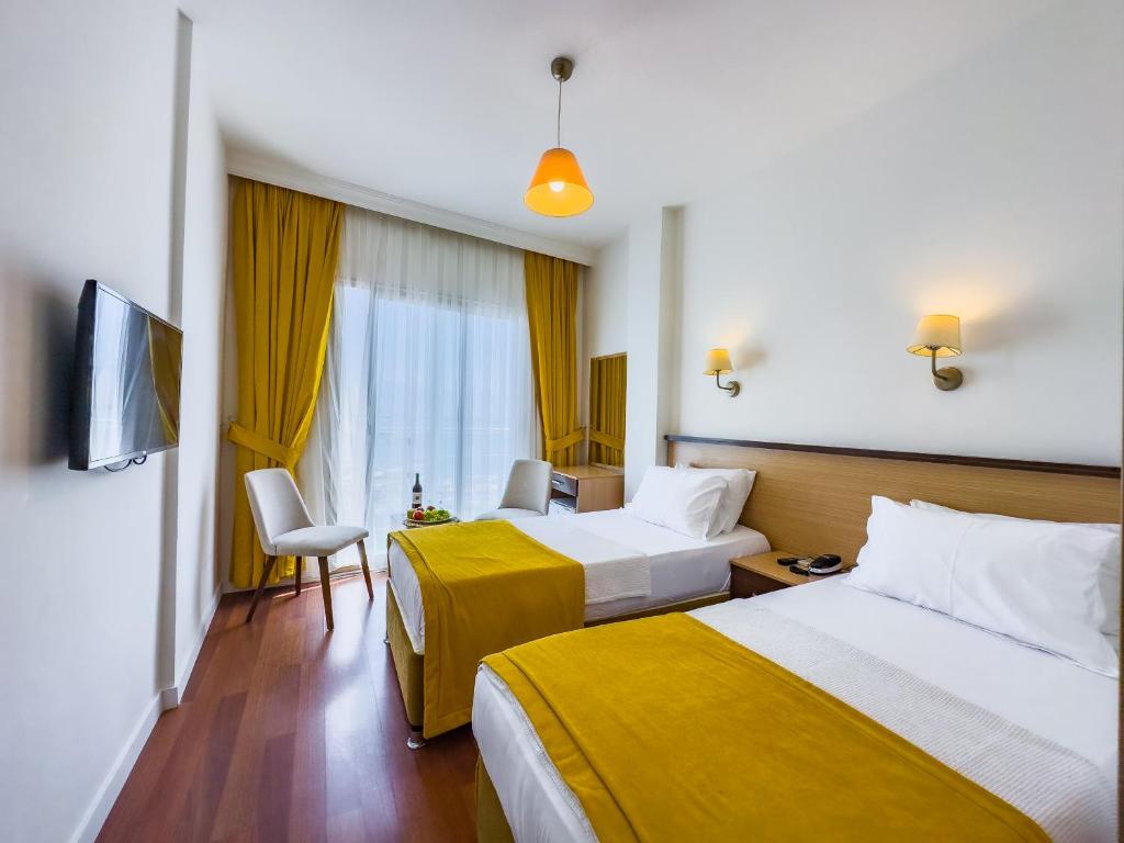 Postel nebo postele na pokoji v ubytování Dedeoğlu Port Hotel