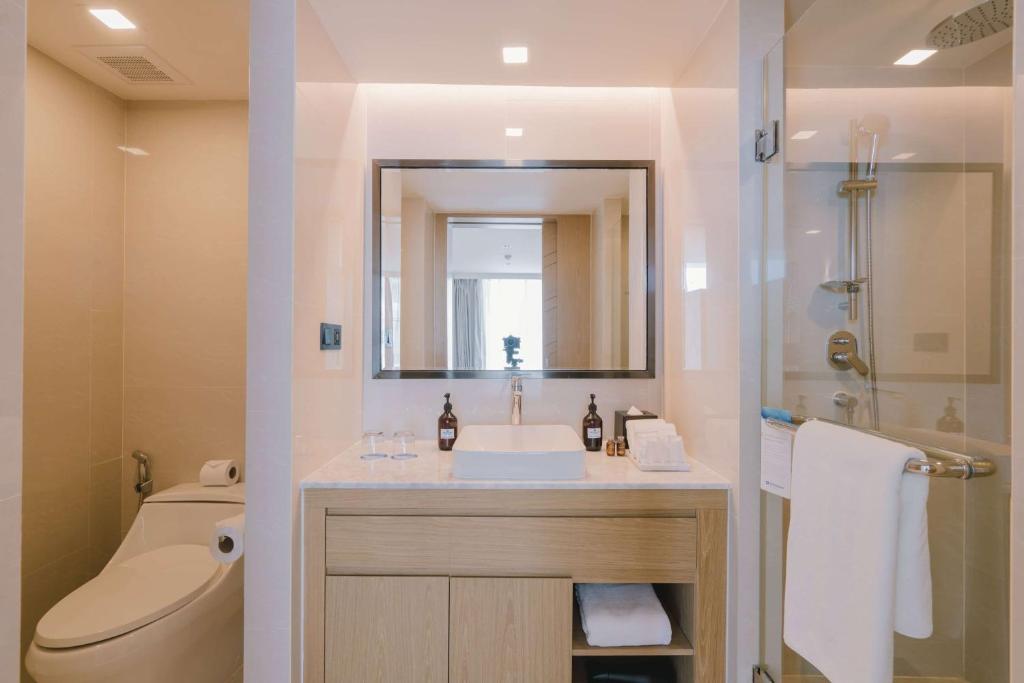 a bathroom with a sink and a shower and a toilet at Wyndham La Vita Rawai Phuket in Rawai Beach