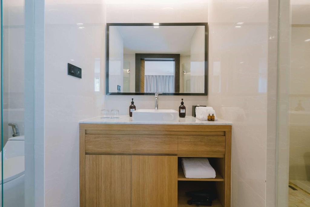 a bathroom with a sink and a mirror at Wyndham La Vita Rawai Phuket in Rawai Beach
