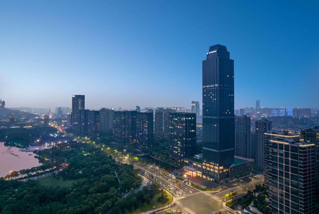 an aerial view of a city with a tall building at Wyndham Shaoxing Keqiao in Shaoxing