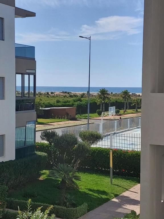 a view of the ocean from a building at Blanca Beach bel appartement avec wifi et Parking in Sidi Rahal