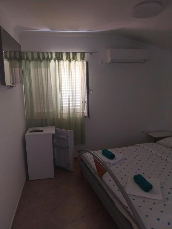 Postel nebo postele na pokoji v ubytování Apartments Leon