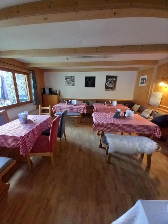 a room with four tables and chairs in a restaurant at Stile Oase Apartment 1 in Bruck an der Großglocknerstraße
