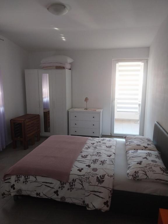 Postel nebo postele na pokoji v ubytování Apartments Leon