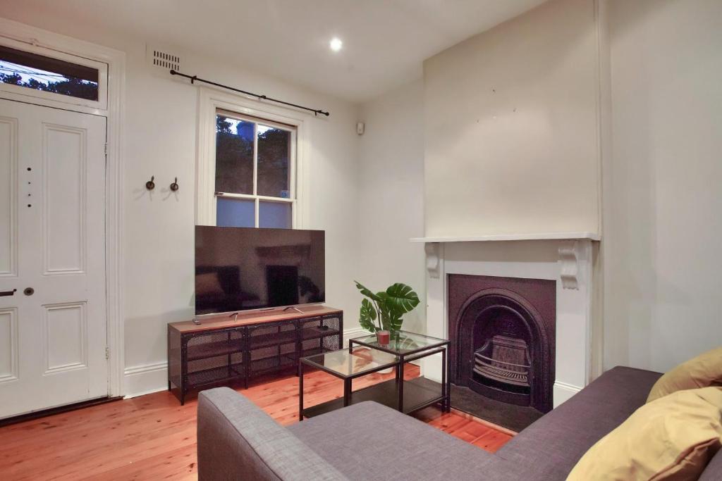 a living room with a couch and a fireplace at 3 Bedrooms - Darling Harbour - Darling St 2 E-Bikes Included in Sydney