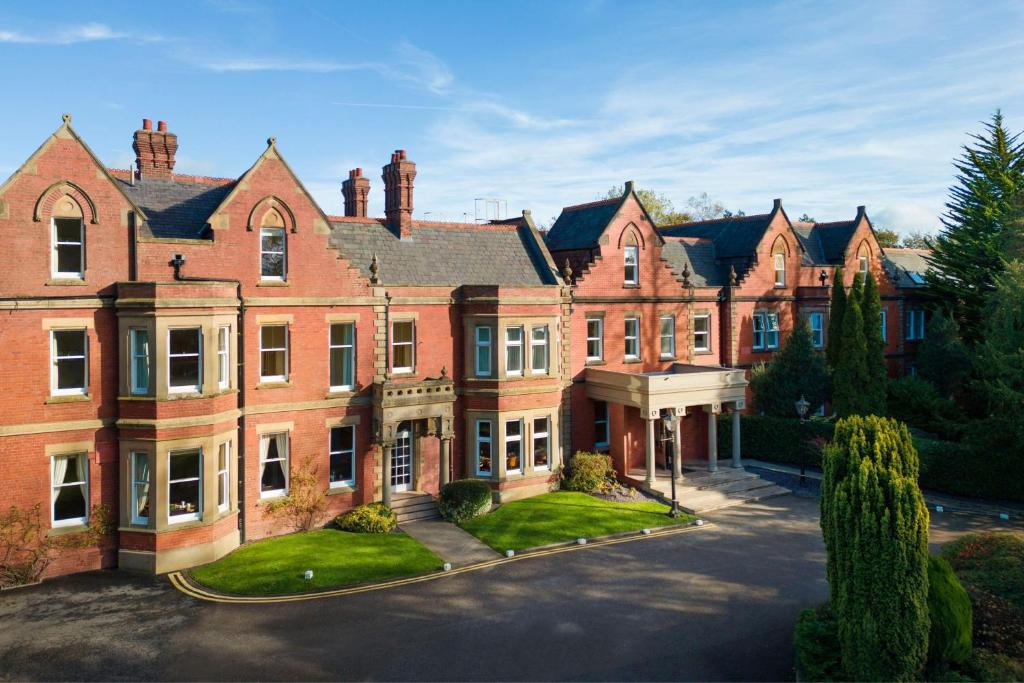 um grande edifício de tijolos vermelhos com uma entrada em Delta Hotels by Marriott Preston em Preston