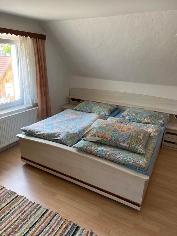 a bedroom with a bed with two pillows on it at Privatzimmer Fohnsdorf in Fohnsdorf