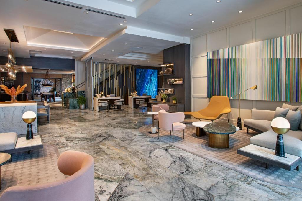 a lobby of a hotel with chairs and tables at Hotel Clio, a Luxury Collection Hotel, Denver Cherry Creek in Denver