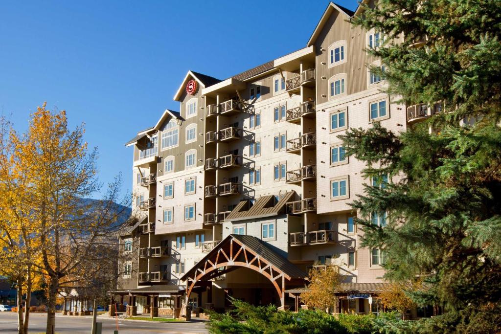 a large apartment building with trees in front of it at Sheraton Mountain Vista Villas, Avon / Vail Valley in Avon