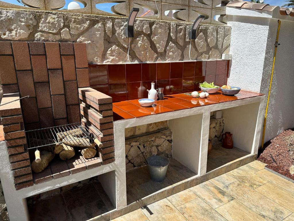a model of a kitchen with a table and bricks at La Duna de Denia in Denia