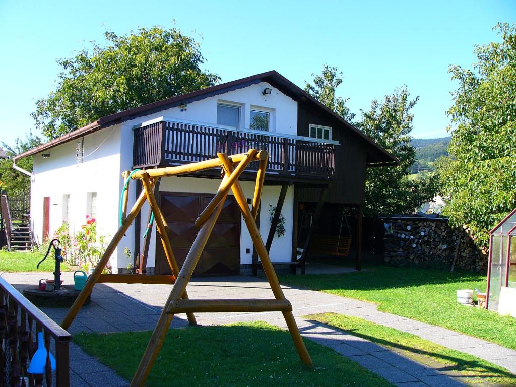 a swing set in front of a house at Apartmán Jeseník Česká Ves in Česká Ves