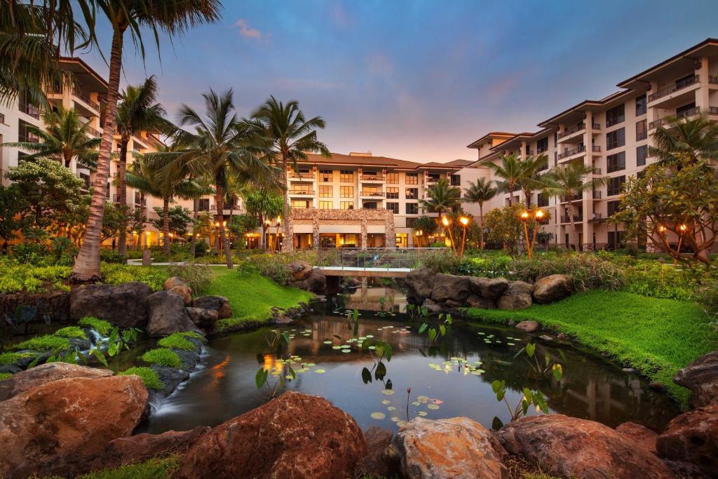 a hotel with a pond in front of a resort at The Westin Nanea Ocean Villas, Ka'anapali in Lahaina