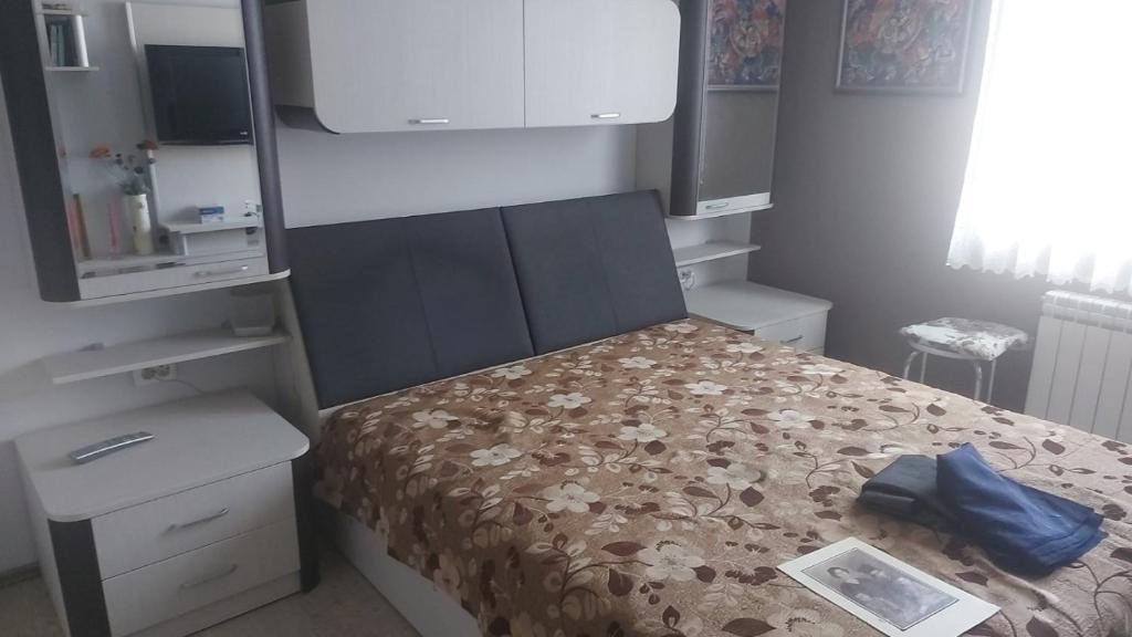 a small bedroom with a bed with a blue bag on it at DRAMA17 in Ruse