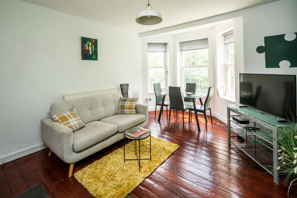 a living room with a couch and a table at Cosy 3BD London accommodation for 6 / 6 beds in London